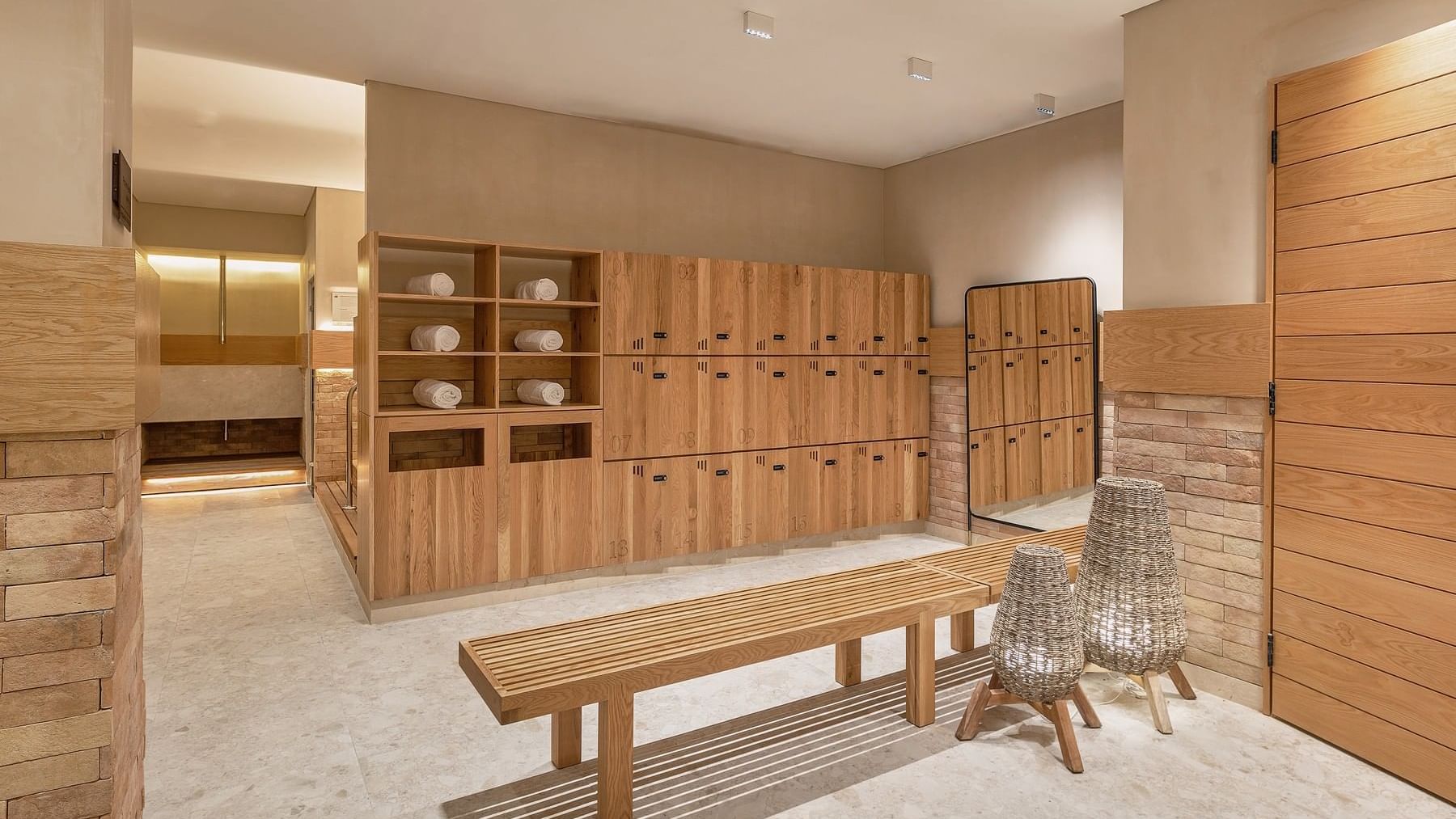 Wooden locker room with benches in the Spa Room at Grand Fiesta Americana