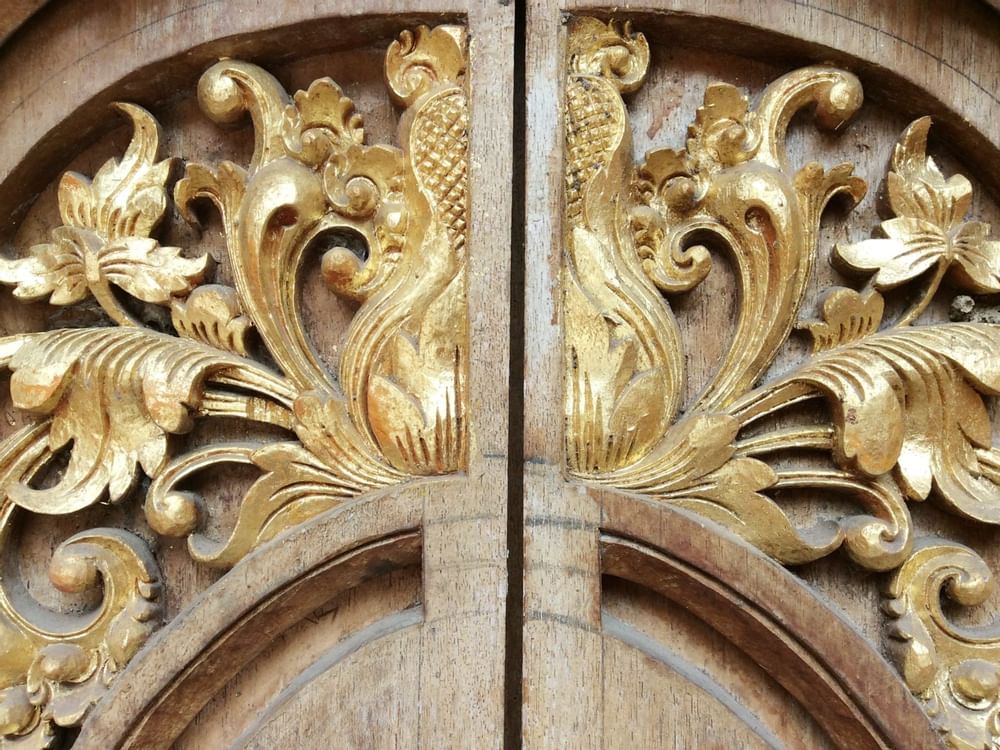 Ancient golden wood carving on a door at Gamma Hotels