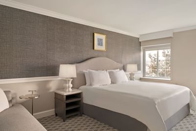 Classic King Room with king bed & lamps at The Madison Hotel