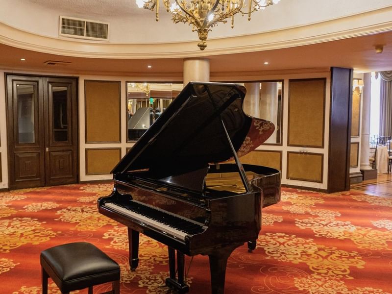 Close-up of a piano in Luis XV Room at Gamma Hotels
