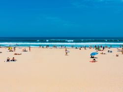 View of bondi beach sand in foreground waves and beach in the background
