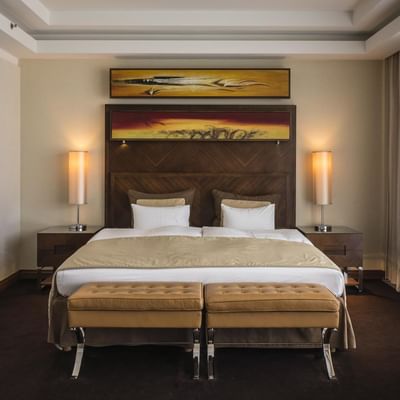 Large bed & lounge in Deluxe Room at Falkensteiner Hotels