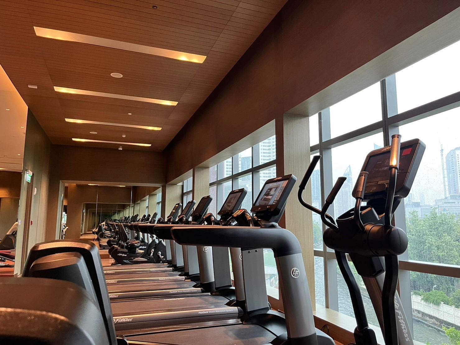 Treadmills in a Gym, city view at Chatrium Hotels & Residences