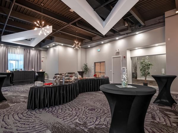 Meeting space with elegantly arranged tables and chairs.