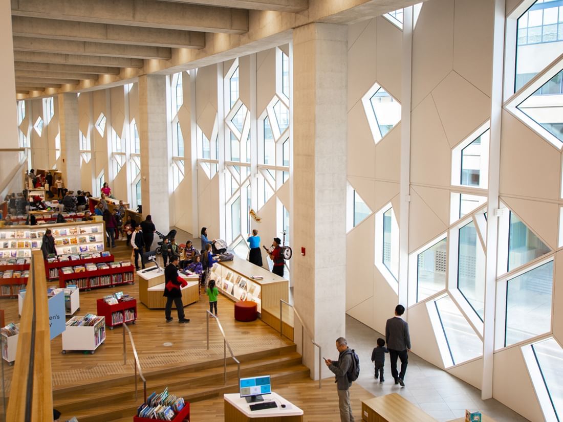 Modern interior of the Central Library with bookshelves near Acclaim Hotel Calgary