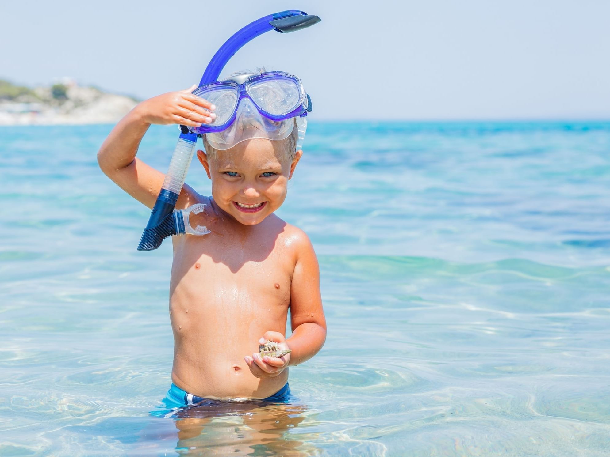 Kid snorkeling in the sea near Daydream Island Resort