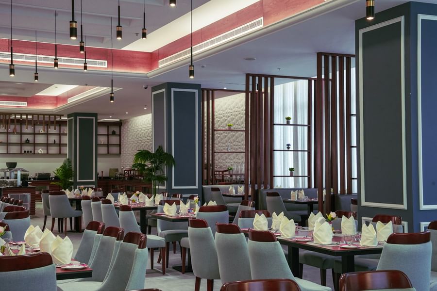 A modern, well-lit restaurant with set tables and chairs at Warwick Hotel & Spa - Jeddah