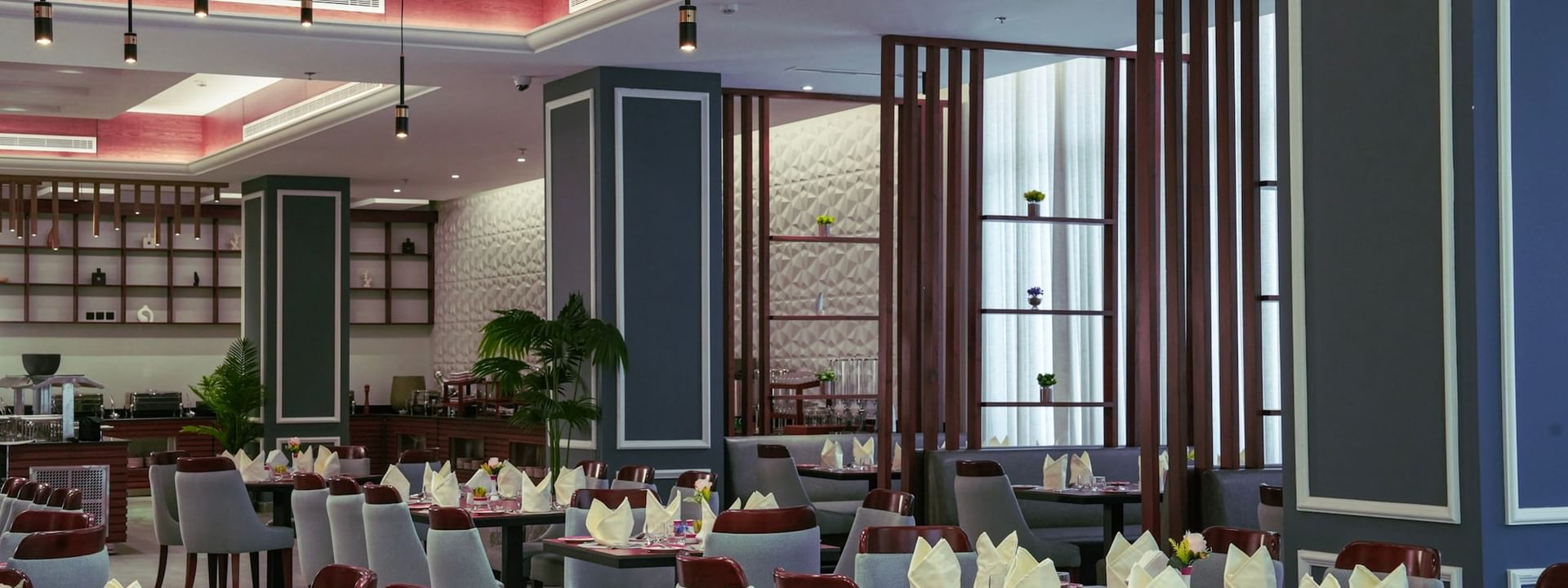 Almir Restaurant interior with set tables and chairs at Warwick Hotel & Spa - Jeddah.