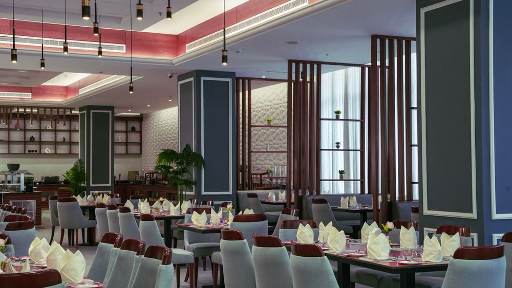 Almir Restaurant interior with set tables and chairs at Warwick Hotel & Spa - Jeddah.