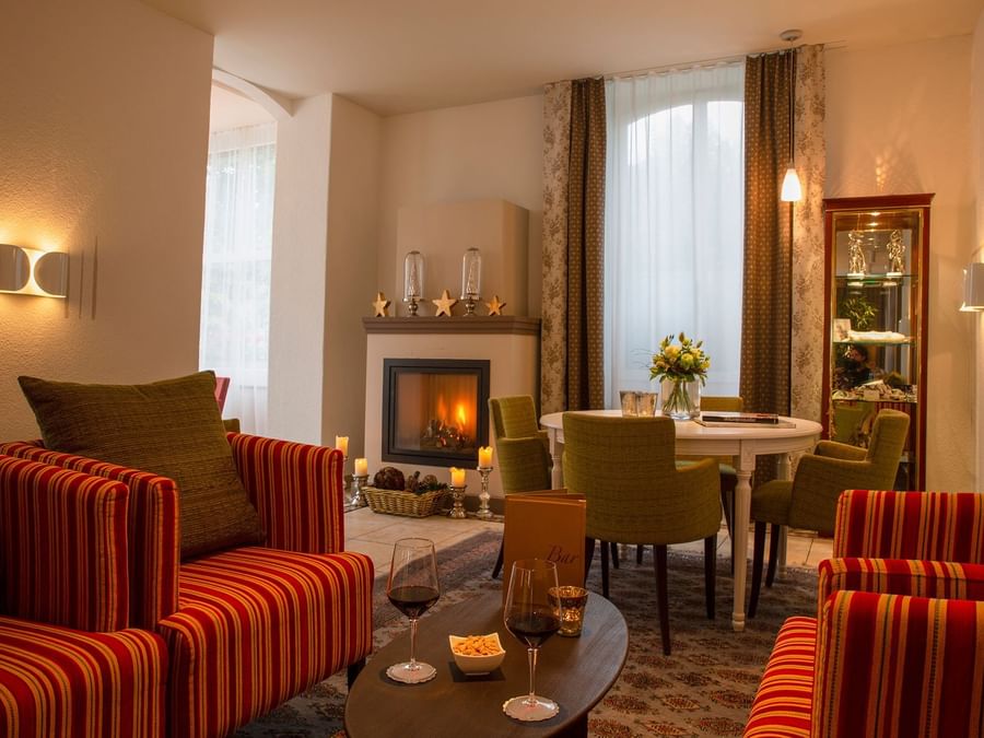 Living area with furniture & wood stove at Chalet hotel bristol