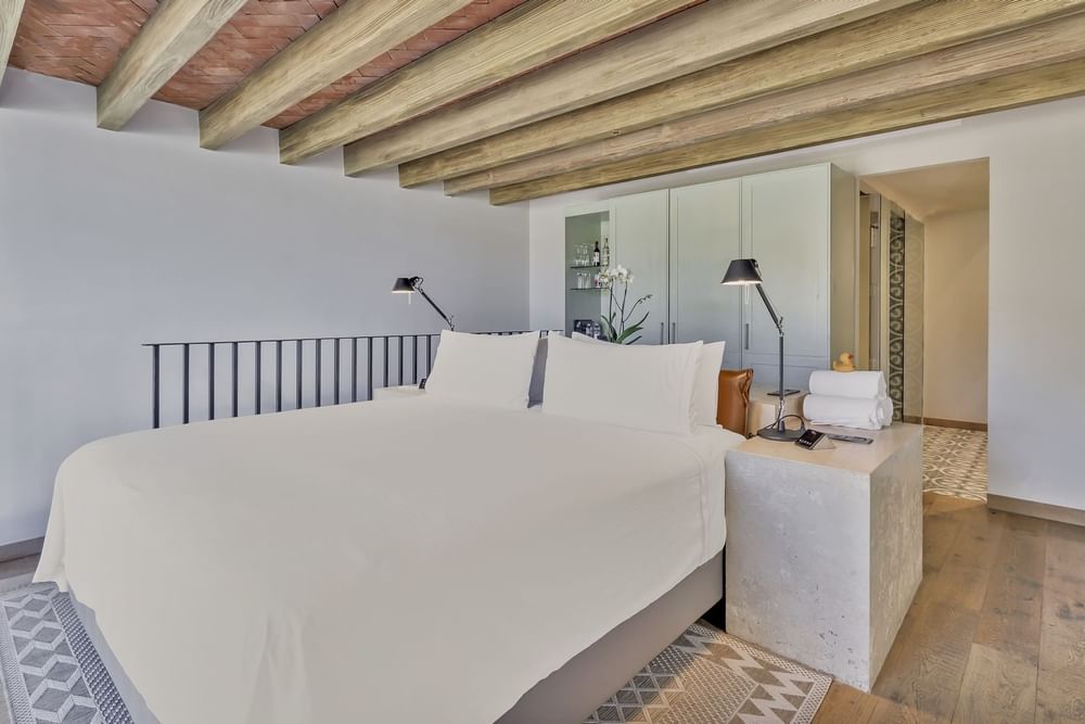Double bed on carpeted floors in a room at Live Aqua San Miguel De Allende