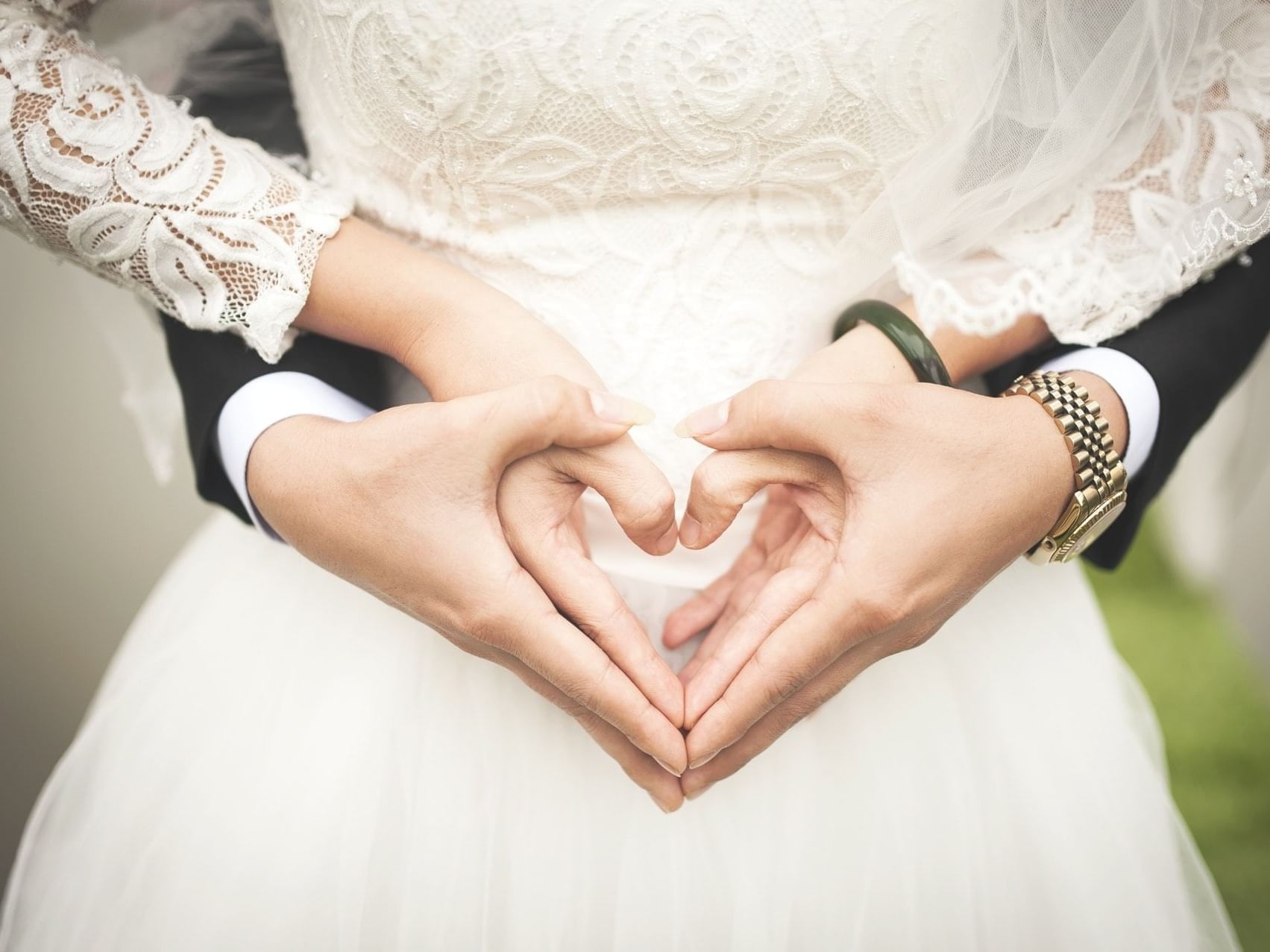 Wedded couple holding hands in a heart shape, Daydream Island