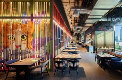 Restaurant dining set-up with wall art in The Market@5 at Eastin Grand Hotel Phayathai