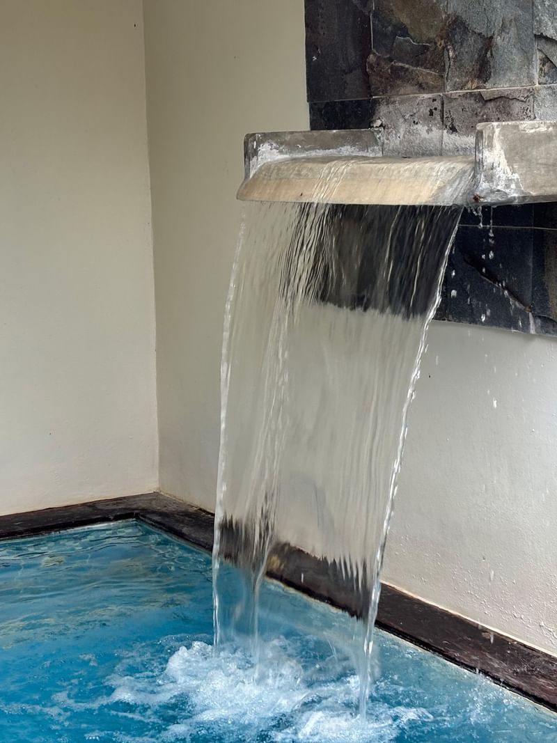Water feature with flowing water into a pool in a Shefa Pool Villa at Warwick Le Lagon - Vanuatu, Efate.