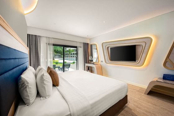 Interior of Amora Ocean Room with modern architecture and a patio overlooking the garden at Amora Hotel
