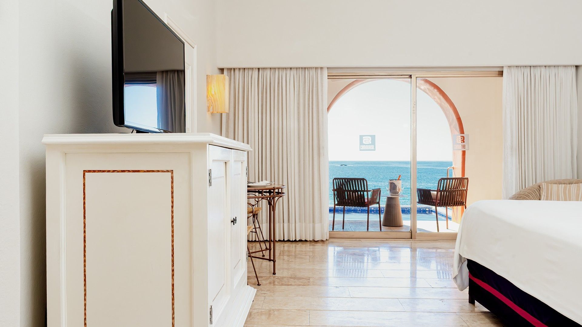 TV & sitting area by the bed in King Camino Real Club with wooden floors and private balcony at Camino Real Zaashila Huatulco