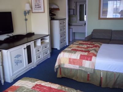 Hotel room with two beds, couch and TV