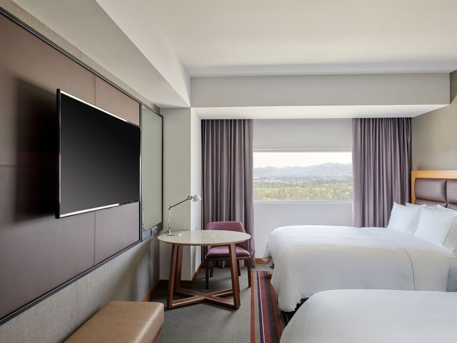 2 Double beds, TV & Table in Junior Suite at FA San Luis Potosí