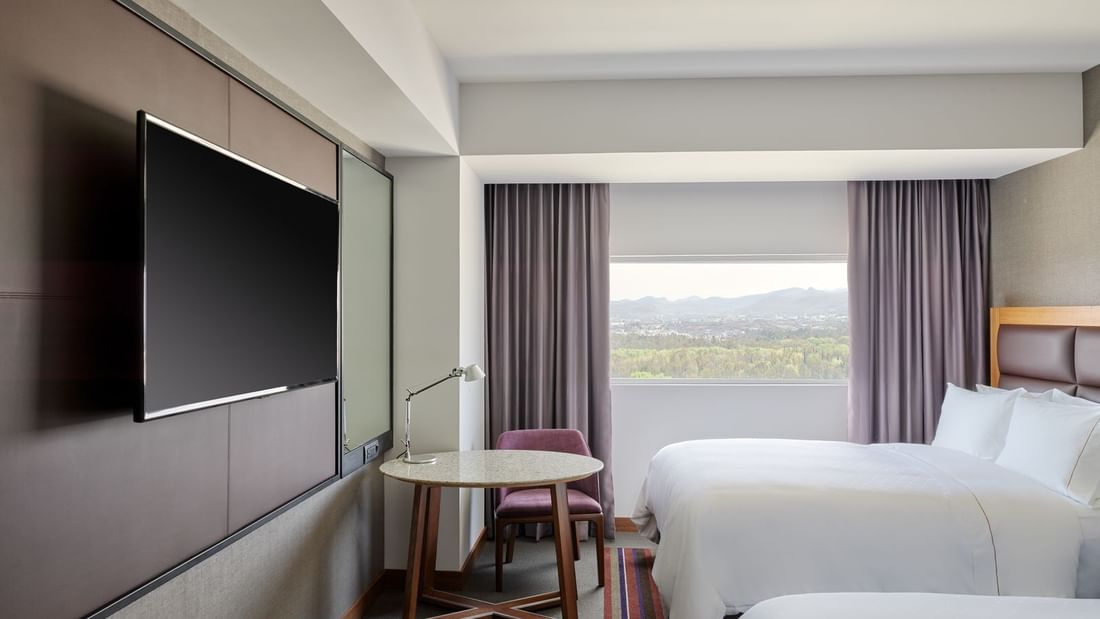 2 Double beds, TV & Table in Junior Suite at FA San Luis Potosí