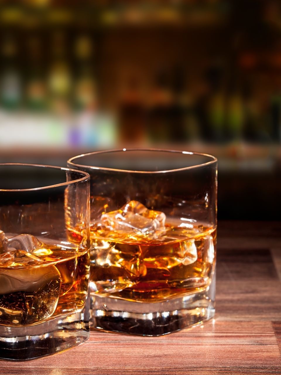 Two glasses of whiskey on Hightide Rooftop Bar, filled with ice at El Conquistador Resort