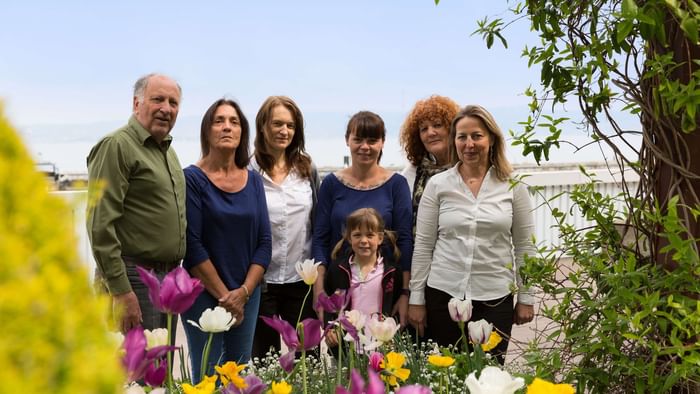 An image of familysmiling in the garden at Hotel Alize