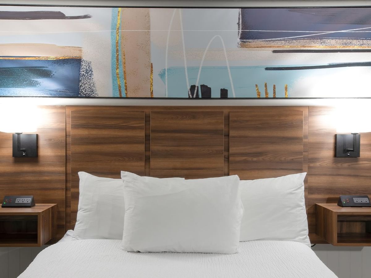 Queen bed with white bedding.