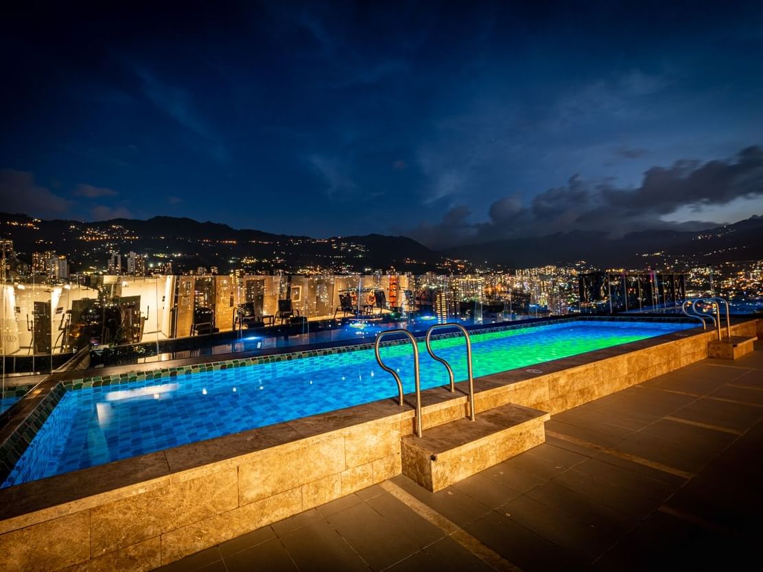Outdoor swimming pool with a city view at Blue Doors Hotels