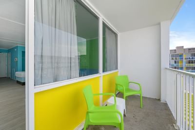 Balcony area with two chair and pool view in HC Ground Floor Poolview Efficiency at Kokomo Suites