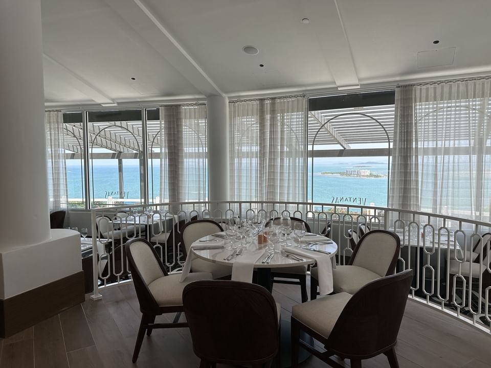 Banquet table arranged in Ventanas Restaurant with sea view backdrop at Las Casitas Village