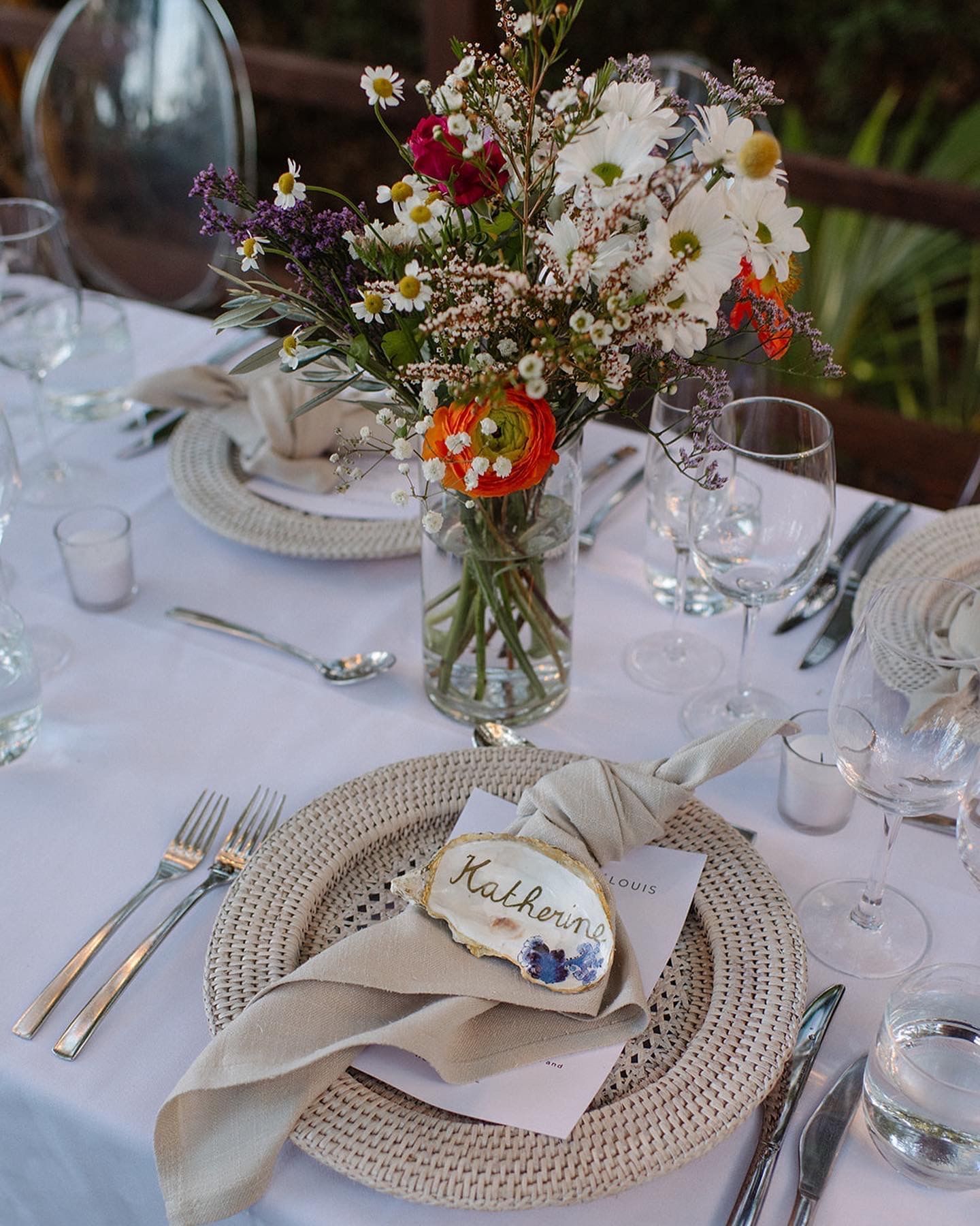 Dining setup with floral centerpiece and personalized place setting at Pullman Port Douglas Sea Temple Resort & Spa