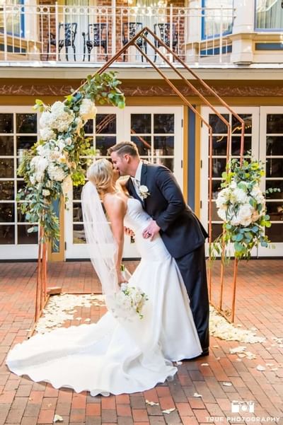 Bride and groom kissing at the altar in Horton Grand Hotel