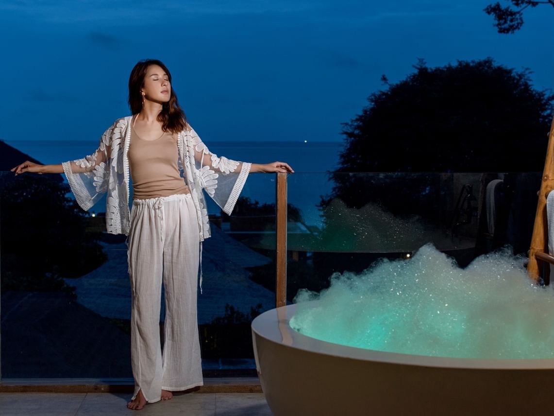 Lady by the jacuzzi on a room balcony at U Hotels & Resorts