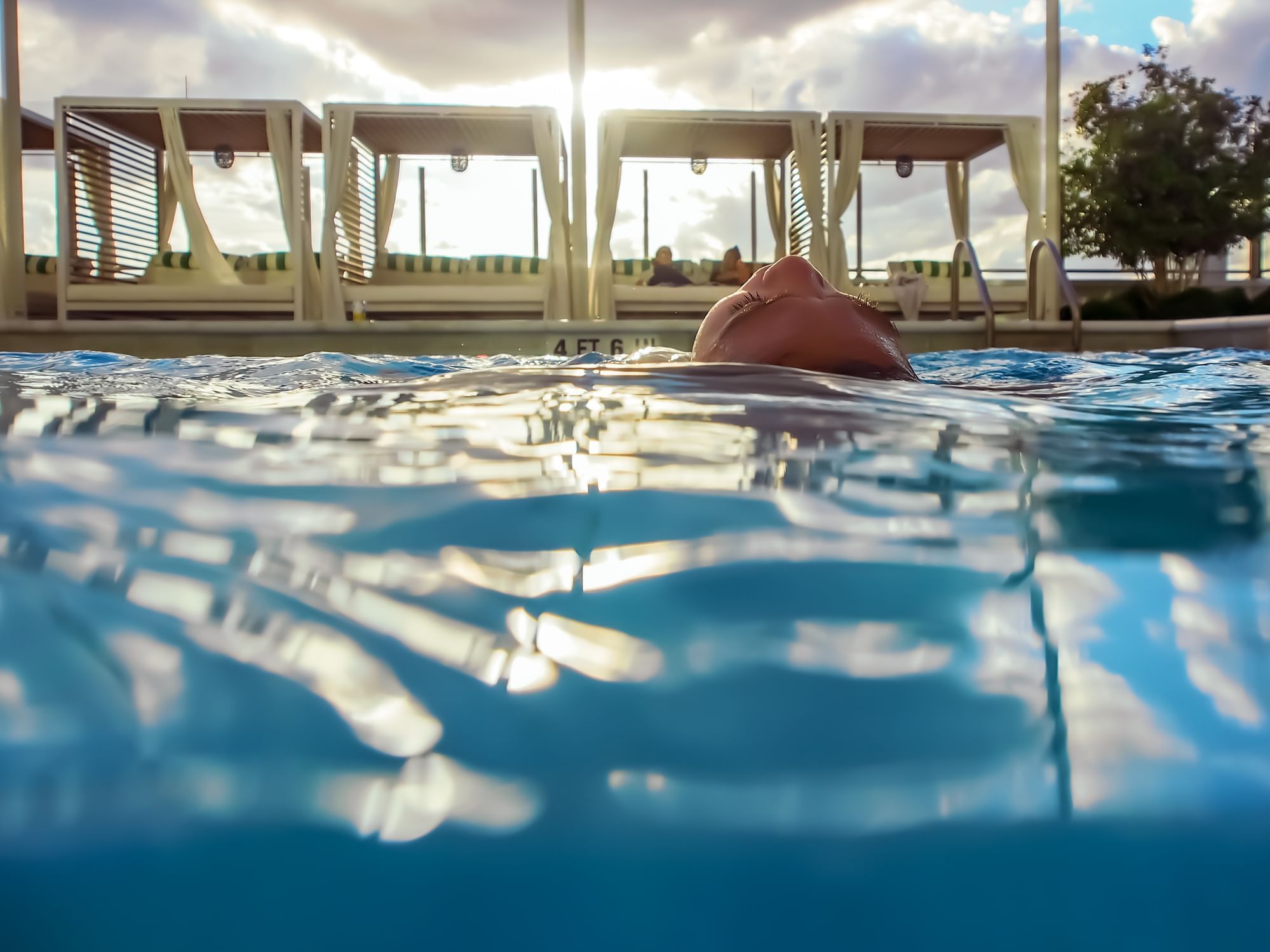 Girl floating on the outdoor pool at Sunseeker Resort