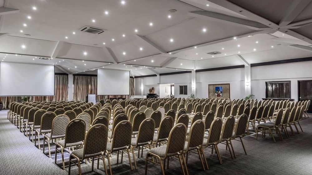 Talanoa Hall with gold-frame chairs by white walls under a lit canopy at Warwick Fiji Resort and Spa
