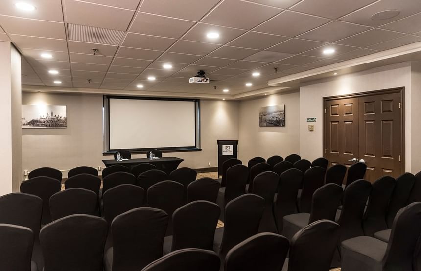 conference room with chairs lined up and projector on wall