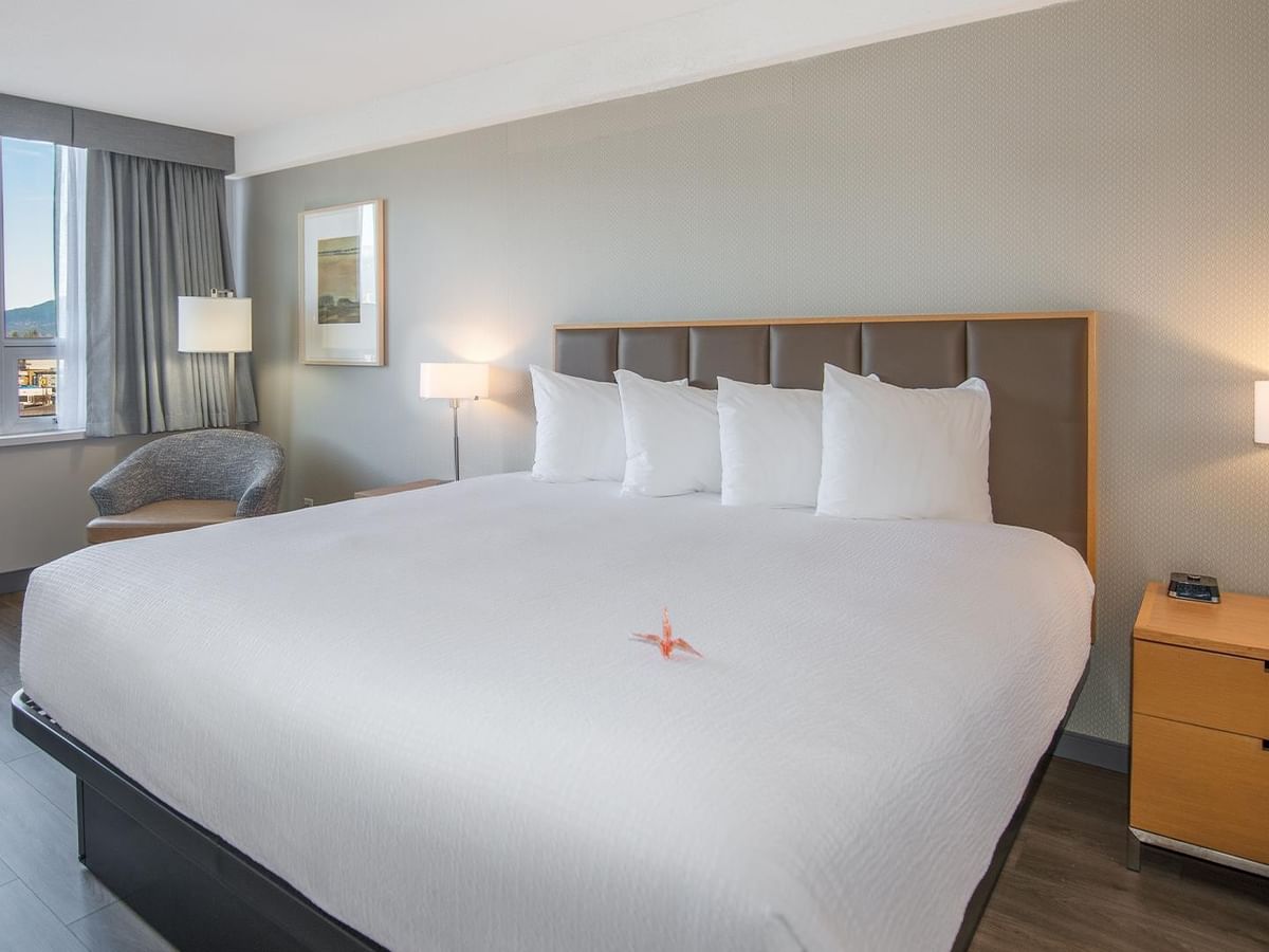 Hotel room with a large king-sized bed and modern decor.