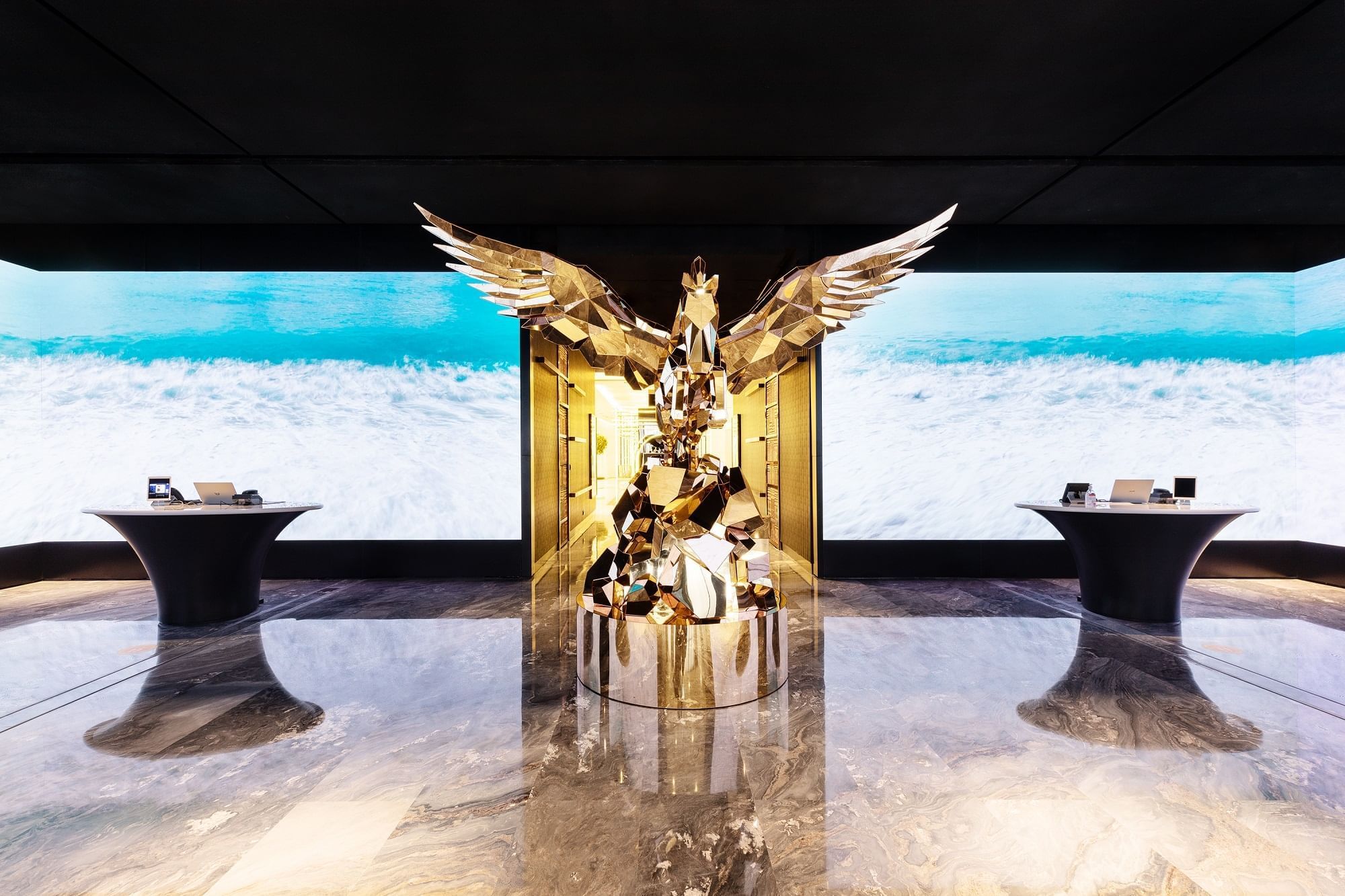 Grand golden statue with a sizable screen by the lobby area at Paramount Hotel Dubai