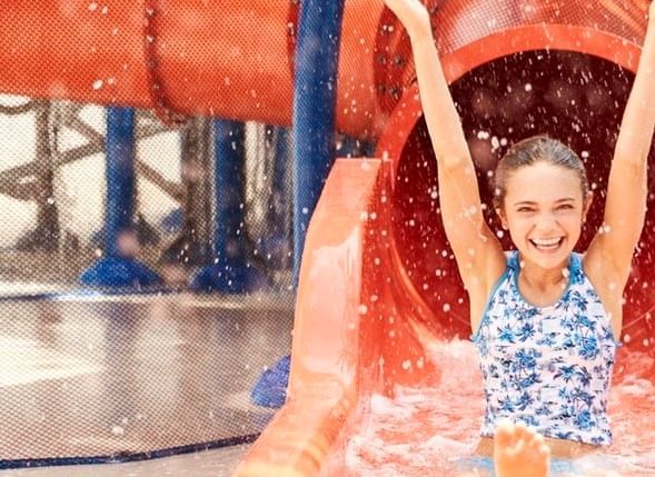 Girl sliding down a waterslide outdoors at The Diplomat Resort