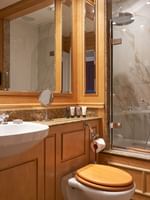 Elegant bathroom with marble and wood features, and a bathtub in Deluxe King at The Capital Hotel, Apartments & Townhouse