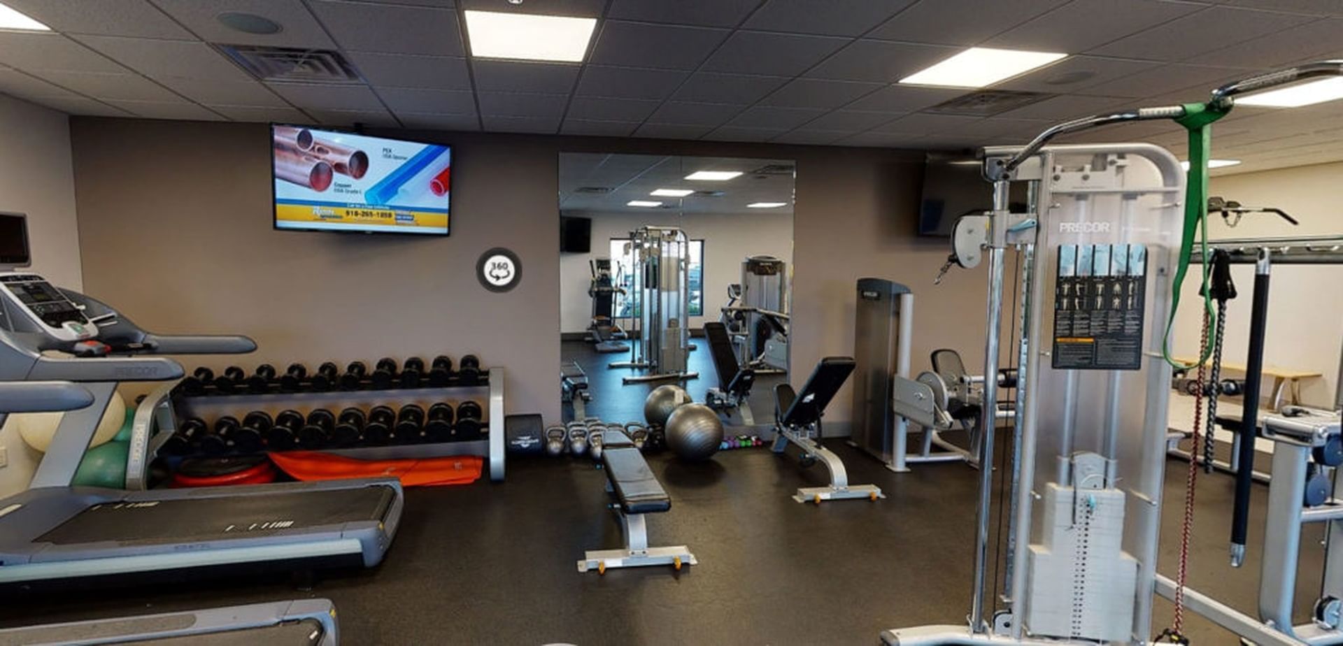 Modern gym with treadmills, free weights, and strength training equipment at Shangri-La Resort and Golf Club