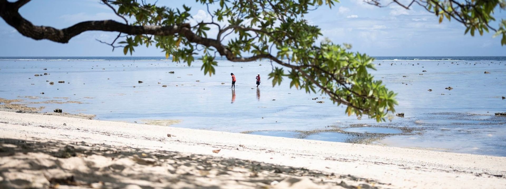 Two people on a sand beach in Korolevu at Warwick Fiji Resort and Spa