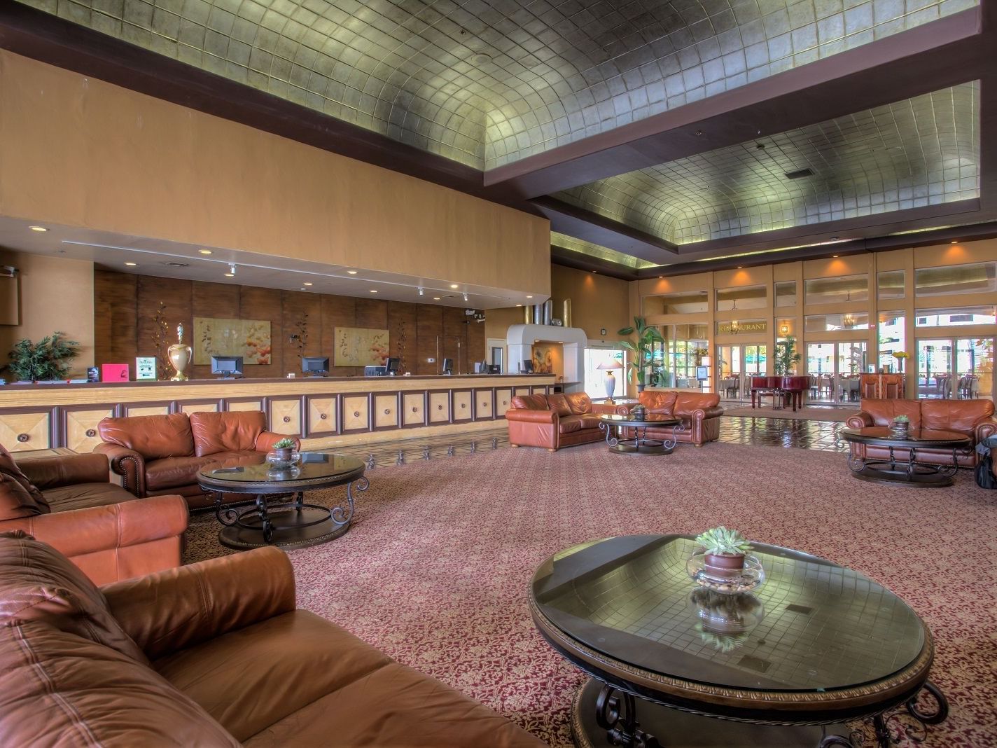 Lobby area with couches & front desk at Alexis Park Resort