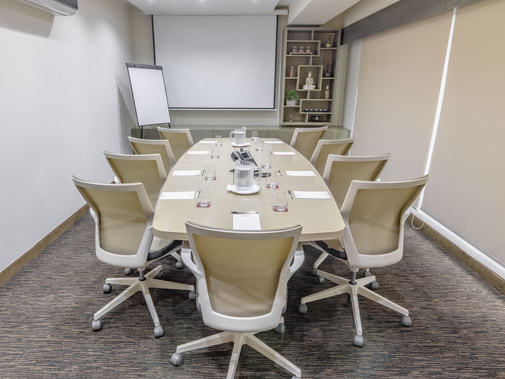 An arranged meeting room with white chairs and a table