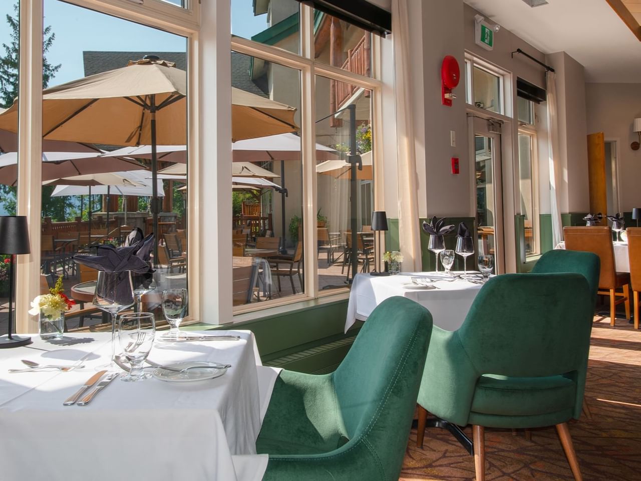 Hotel restaurant with dining table, chairs and patio