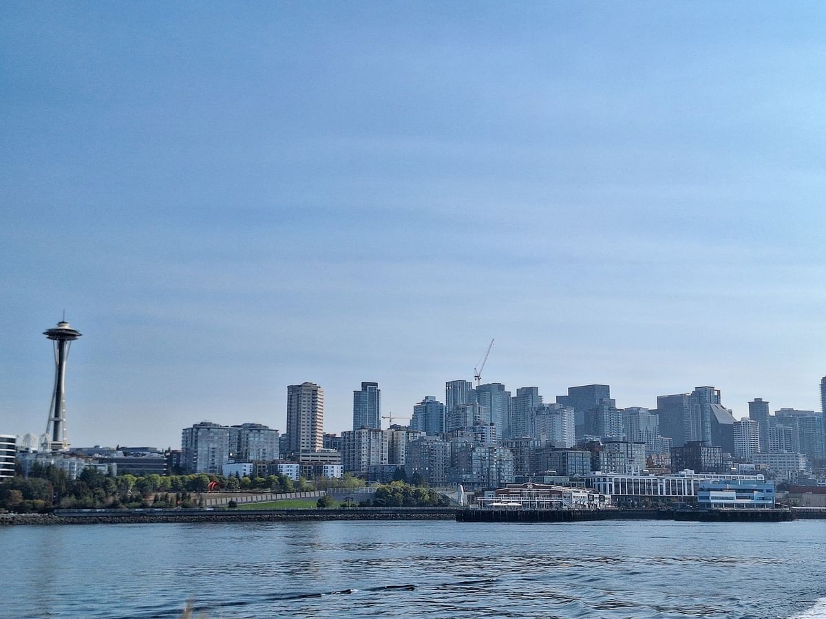 City skyline with the Space Needle by the waterfront under a clear blue sky near Warwick Seattle