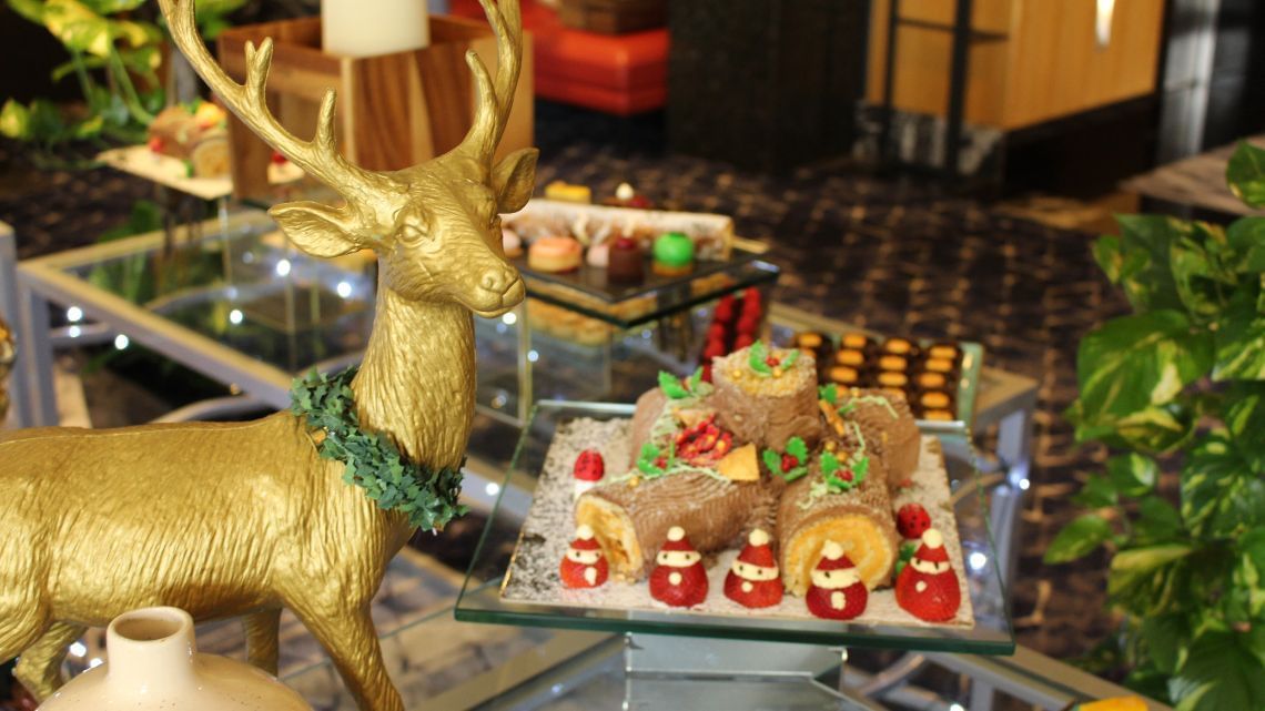 A gold deer statue with Christmas desserts served at Amora Hotel Jamison Sydney
