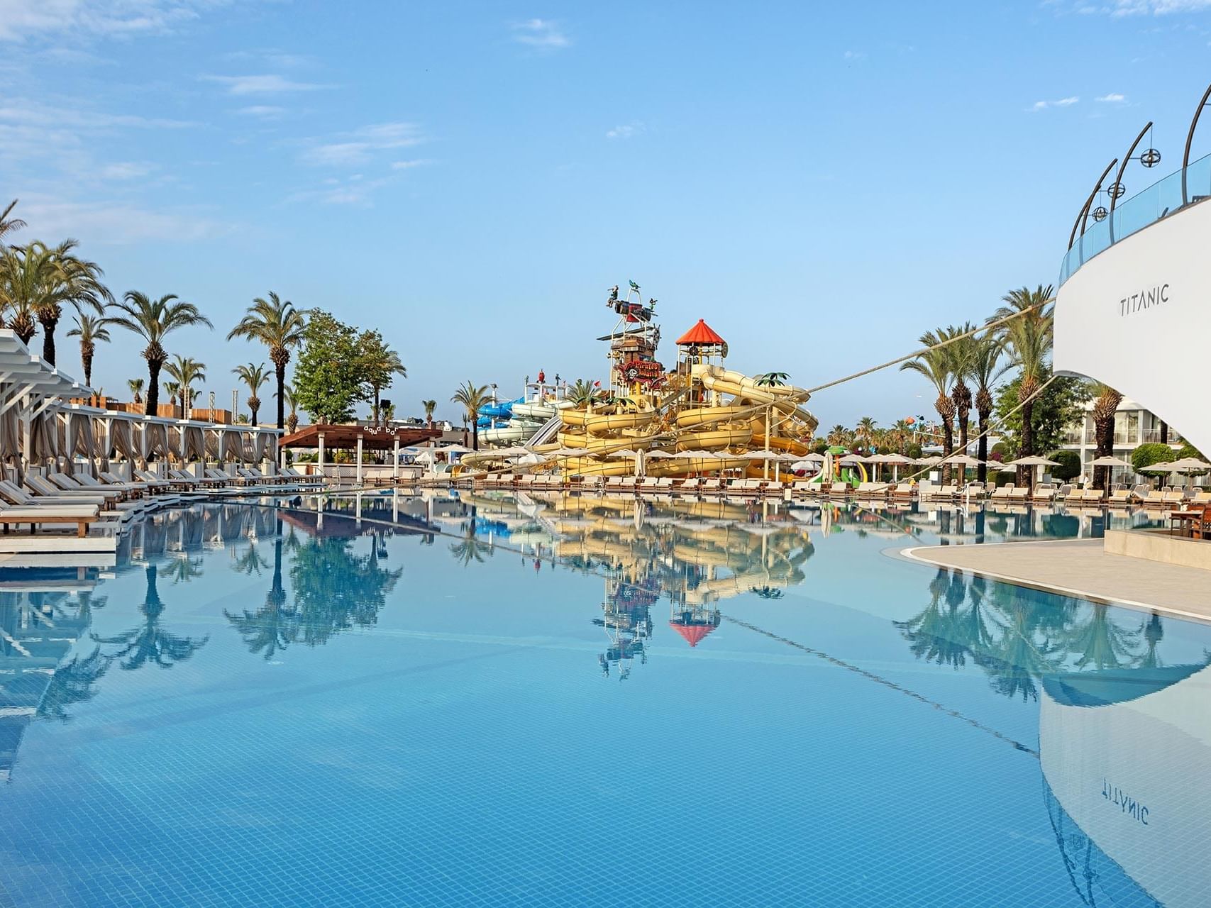 Sun loungers arranged by Olympic Pool outdoors at Titanic Deluxe Lara