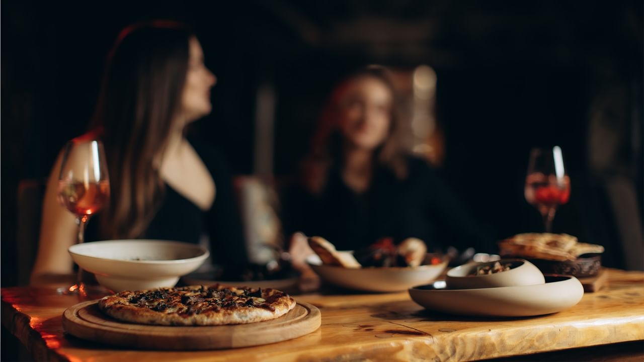 Women dining with wine at Green Gables Restaurant & Lounge at Coast Whitecourt Hotel, Whitecourt.