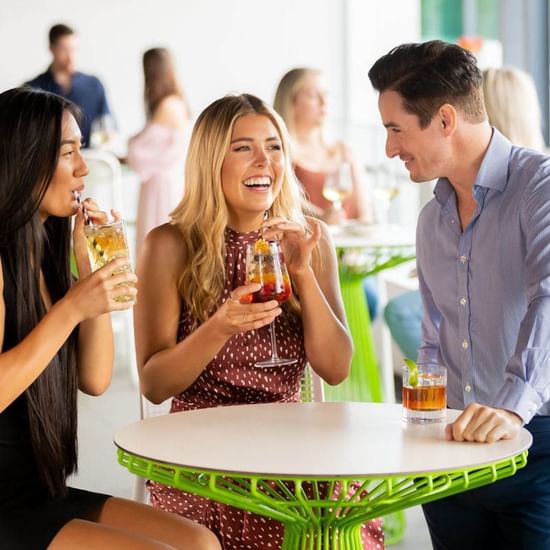 People enjoying drinks in Shallows Bar at Pullman Magenta Shores Resort