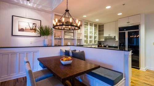 Dining area arrangement with chandelier light in Premium Resort suite at Watersound Inn
